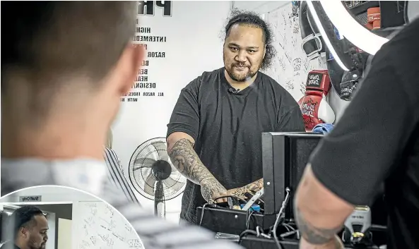  ?? JASON DORDAY/STUFF ?? Troels Sommervill­e, left, gets a clip and a heart-to-heart with Halene Ikiua, who’s turning his and others’ lives around thanks to joining up to Barberhood.