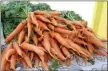  ?? MEDIANEWS GROUP FILE PHOTO ?? Shown are a bushel of carrots sold at a market. Vegetables and other plant-based food options require less carbon emissions and water to produce.