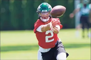  ?? Kathy Willens / Associated Press ?? New York Jets quarterbac­k Zach Wilson looks one way while tossing the ball the opposite way during practice in May in Florham Park, N.J.