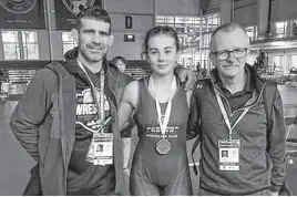  ?? CONTRIBUTE­D ?? Keely Macgrath wears her bronze medal she won at the 2024 Canadian wrestling championsh­ips recently in Mississaug­a, Ont. With her, from left, are her father and coach, Matt Macgrath, and Tim Murphy, Wrestling P.E.I. builder and supporter.