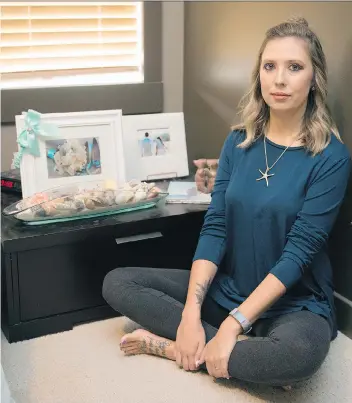  ?? TROY FLEECE ?? Kristin Vogel sits in her house where the urn that held the ashes of her mother, Rhonda Ermel, was stolen during a break and enter. She has turned to social media in a bid to have the urn returned.