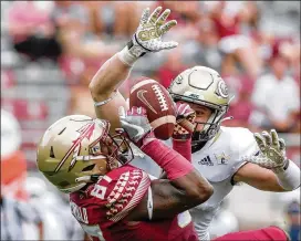  ?? DON JUAN MOORE / CHARACTER LINES ?? FSU tight End Camren McDonald makes a catch over Tech linebacker David Curry during Saturday’s game. The Yellow Jackets forced three fumbles in the second half, made an intercepti­on and locked down the Seminoles.