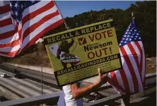  ?? Jae C. Hong / Associated Press ?? The pro-recall movement included displays like Zig Jiang’s on a bridge overlookin­g a Los Angeles freeway on Sept. 8.