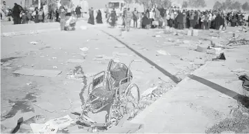  ??  ?? A wheelchair left by displaced Iraqis fleeing their homes is pictured as Iraqi forces battle with Islamic State militants, in western Mosul, Iraq. — Reuters photo