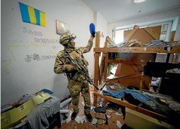  ?? AP ?? A Russian soldier inspects an abandoned base of Ukraine’s Azov Regiment in Yuriivka, near Mariupol in eastern Ukraine. Nearly 1000 Ukrainian fighters who had held out inside Mariupol’s Azovstal steel plant surrendere­d yesterday, as the battle that turned the city into a worldwide symbol of defiance and suffering drew to a close.