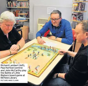  ??  ?? Richard Lambert (left), Paul Kerfoot (centre) and John McCarthy play the Battle of Little Bighorn board game at Mirfield Library