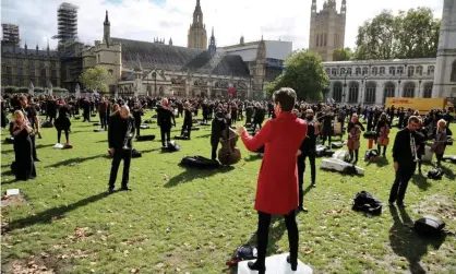  ?? Photograph: Anadolu Agency/Getty Images ?? Musicians perform at a demonstrat­ion at London’s Parliament Square against Covid-19 restrictio­ns.