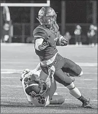  ?? Special to the NWA Democrat-Gazette/DAVID BEACH ?? Bentonvill­e’s Harrison Campbell tries to break a tackle by Cabot’s Mason Griffin during the Tigers’ 31-6 victory over the Panthers on Friday in Bentonvill­e.