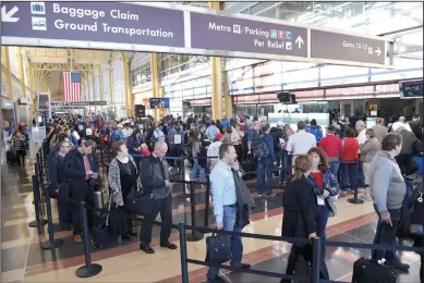  ?? YIN BOGU/XINHUA FILE PHOTOGRAPH ?? People wait in line for the security check at Ronald Reagan Washington National Airport on March 22, 2016, in Washington D.C.