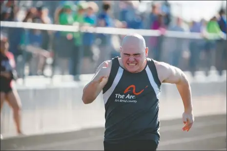  ?? (Courtesy Photo/Gary Schottle) ?? Derek “Tank” Schottle competes in the 100-meter dash as part of the pentathlon at a Special Olympics track meet in Rosenburg, Texas, in 2017. When Tank was younger, his father arrived at the school in time to see the other kids in line hitting and jumping on his young son. Gary Schottle had the same thoughts any other parents would, wondering how the kids could be so mean and why Derek didn’t stick up for himself. Special Olympics changed everything for Tank.