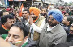  ??  ?? JALANDHAR: In this photograph taken on January 26, 2017, Indian cricketer-turned-politician and current Congress Party candidate for the Punjab Legislativ­e Assembly Navjot Singh Sidhu (C) greets supporters at an election rally. — AFP