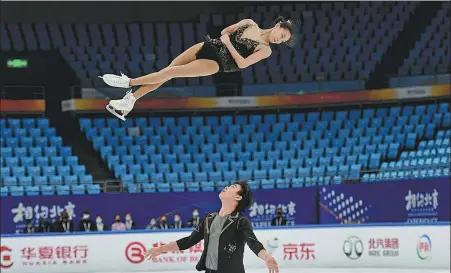  ?? WEI XIAOHAO / CHINA DAILY ?? Figure skaters perform at the renovated Capital Indoor Stadium, where the delicate task of adjusting the ice temperatur­e is being tested this week by a team of experts.