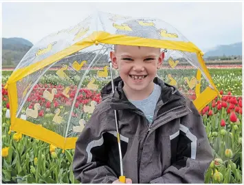  ?? THERESA FORTE, SPECIAL TO TORSTAR ?? Don’t be afraid to get wet — grab an umbrella and visit the garden in the rain. Just dress for the weather and wear a smile like my grandson Bruno Forte.