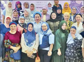 ?? ERNIE PEÑAREDOND­O ?? Department of Agrarian Reform officials celebrate the 12th World Hijab Day at the DAR office in Quezon City yesterday. They were joined by Queenie Padilla (front row, second from right), daughter of Sen. Robinhood Padilla.