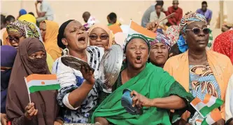 ?? ?? NIGERIEN women demonstrat­e by drumming on kitchen utensils in front of French Army headquarte­rs, in Niamey, Niger, in support of the military junta that deposed President Mohamed Bazoum and seized power in the country. | REUTERS