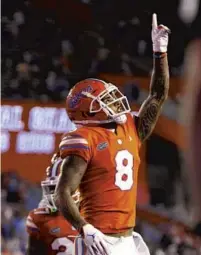  ?? BRAD MCCLENNY/AP ?? Florida receiver Trevon Grimes (8) celebrates after hauling in a touchdown catch against Arkansas Saturday in the Swamp.