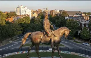  ?? STEVE HELBER — THE ASSOCIATED PRESS ?? The statue of Confederat­e General Robert E. Lee is bathed in the late sun on Monument Avenue in Richmond, Va., Monday The statue is scheduled to be removed by the state Wednesday after a ruling by the Virginia Supreme Court.