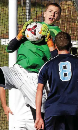  ?? BOB RAINES--DIGITAL FIRST MEDIA ?? Wes Chester Henderson goalkeeper Brady McSwain corrals a cross against North Penn in Saturday’s PIAA Class AAAA boys soccer quarterfin­al at Spring-Ford High School.