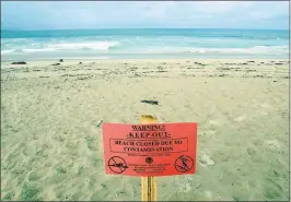  ?? VERN FISHER — MONTEREY HERALD ?? A beach closure sign is posted at Monterey State Beach on Monday after sewage spilled into Monterey Bay.