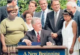  ?? ?? President Bill Clinton prepares to sign legislatio­n overhaulin­g America’s welfare system on Aug. 22, 1996, in the Rose Garden of the White House.
J. SCOTT APPLEWHITE/AP