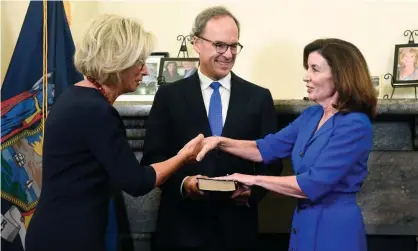  ?? Photograph: Hans Pennink/AFP/Getty Images ?? New York’s chief judge, Janet DiFiore, swears in Kathy Hochul, right, as the first woman to be New York’s governor in Albany.