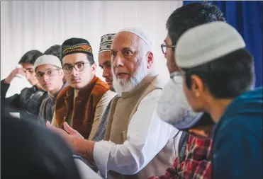  ?? Canadian Press photo ?? Calgary Imam Syed Soharwardy, centre, founder of Muslims Against Terrorism and the Islamic Supreme Council of Canada, speaks to Muslim youth about anti-radicaliza­tion strategies at a mosque in Calgary earlier this month.