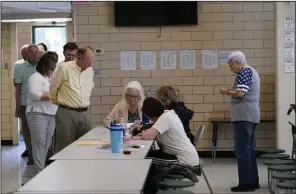  ?? (AP/Gerald Herbert) ?? People line up to vote at a polling spot Saturday at St. Rita’s Catholic School on election day in Harahan, La.