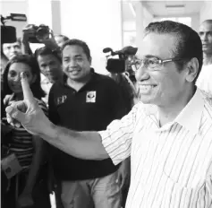  ??  ?? Guterres of the Fretilin party shows his ink marked finger after casting his ballot. — Reuters photo