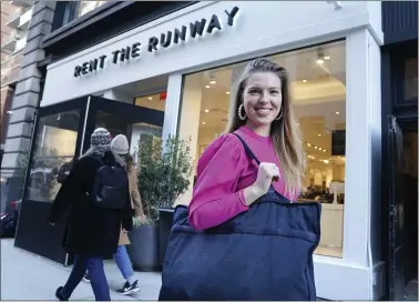  ?? SETH WENIG — THE ASSOCIATED PRESS ?? Vara Pikor poses for a picture in front of a “Rent The Runway” store before returning some items in New York. Pikor is wearing some of the items she rents from the company, including her dress and earrings.