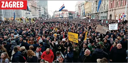  ?? ?? ANGER: Police face down anti-restrictio­ns demonstrat­ors in Milan, left. Above: Crowds in Ban Jelacic Square, Zagreb