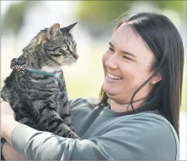  ??  ?? ANIMAL THERAPY: Courtney Gerdtz will walk 75 kilometres this month to raise money for Black Dog Institute’s One Foot Forward campaign. Ms Gerdtz has opened up about her mental health struggles in the hope it will encourage others to speak up and seek support. She considers her cat, Kevin, one of her biggest supporters. Picture: PAUL CARRACHER