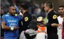  ?? Photograph: Benoît Tessier/Reuters ?? Dimitri Payet walks off the pitch with an ice pack to his head.