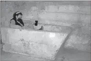  ?? Photos by Doug Walker ?? Left, Bottom: HPC member Brandie Townsend tries out a concrete bathtub in the crawl space. Below: Members of the Rome Historic Preservati­on Commission tour the renovation work nearing completion.