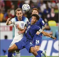  ?? Clive Mason / Getty Images ?? Tyler Adams of United States controls the ball under pressure of Harry Kane of England during their match on Friday.