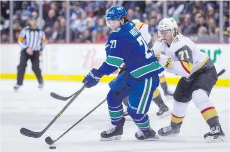  ??  ?? Canucks defencemen Ben Hutton fights off the check of Golden Knights forward William Karlsson on Thursday.