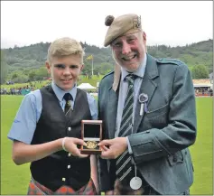  ?? 16_T35_Argyllshir­e Gathering_23 ?? The winner of the President’s Gold Medal, Gregor MacDonald, 14, of North Connel, with piping steward Torquil Telfer.