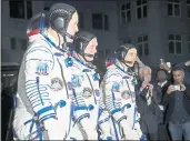  ?? DMITRI LOVETSKY — THE ASSOCIATED PRESS, POOL ?? Russian cosmonaut Oleg Artemyev, center, with U.S. astronauts Richard Arnold, right, and Andrew Feustel, before the launch Wednesday of the Soyuz MS-08 space ship for a mission aboard the Internatio­nal Space Station.