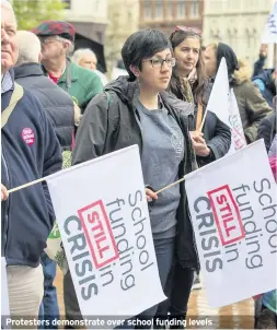  ??  ?? Protesters demonstrat­e over school funding levels