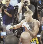  ?? AP PHOTO ?? MEDIA STORM: Conor McGregor trains in front of reporters and cameras Aug. 11 in Las Vegas.