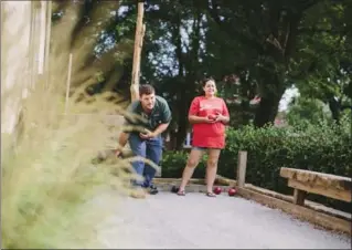  ?? COLIN CONCES, SUN VALLEY LANDSCAPIN­G VIA AP ?? Jerrod and Paige Combs play bocce at a backyard party in Omaha, Neb.