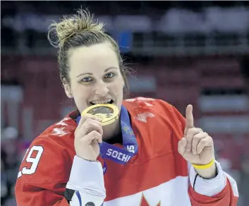  ?? JONATHAN NACKSTRAND/ GETTY IMAGES ?? Canada’s Marie- Philip Poulin celebrates with her gold medal during the 2014 Sochi Winter Olympics women’s hockey victory ceremony, at the Bolshoi Ice Dome on Feb. 20, 2014.