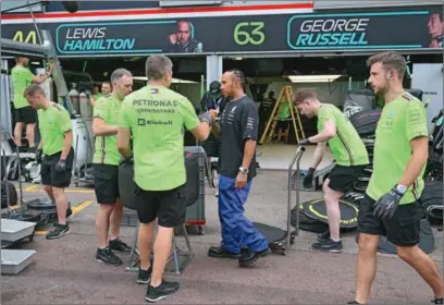  ?? (AFP) ?? Mercedes’ British driver Lewis Hamilton reacts with team members in the pits after the the Formula One Monaco Grand Prix at the Monaco street circuit in Monaco, on Sunday.