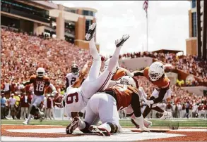  ?? Tim Warner / Getty Images ?? Alabama quarterbac­k Bryce Young gets a pass away in his end zone after being hit by Texas’ T’Vondre Sweat (93) in the third quarter on Saturday in Austin, Texas.
