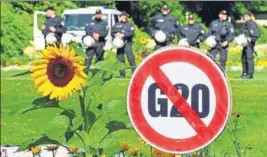  ?? REUTERS ?? A G20 protest sign in front of a row of policemen in Hamburg, the venue of this year’s summit.