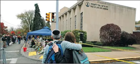  ??  ?? People pay their respects yesterday at a makeshift memorial outside the Tree of Life synagogue in Pittsburgh.