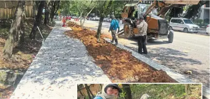  ?? ?? Newly laid concrete footpath along Jalan selangor in Federal Hill, with the bare patch to be planted with grass. (inset) The site supervisor pointing to drain inlets replacing damaged ones.