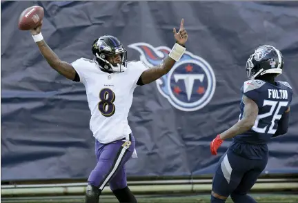  ?? MARK ZALESKI — THE ASSOCIATED PRESS ?? Baltimore Ravens quarterbac­k Lamar Jackson (8) celebrates after scoring a touchdown on a 48-yard run against the Tennessee Titans in the first half of an NFL wild-card playoff football game Sunday, in Nashville, Tenn. At right is Titans cornerback Kristian Fulton (26).