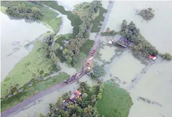  ?? — Reuters file photo ?? An aerial view shows partially submerged road at a flooded area in Kerala.