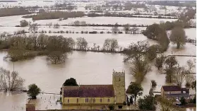  ?? Picture: PA ?? Rising threat…floods surround the church at Tirley, Glos, in February