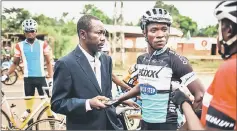  ??  ?? President of the Central African Cycling Federation Christ-Noel Yaraf greets members of Bangui’s cycling team. — AFP photo